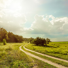 Image showing road near forest under sun with low clouds