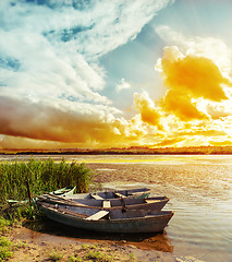 Image showing colored sunset over river with boats