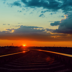 Image showing low sun over railroad to horizon in sunset