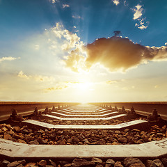Image showing sunset with clouds over railroad close up