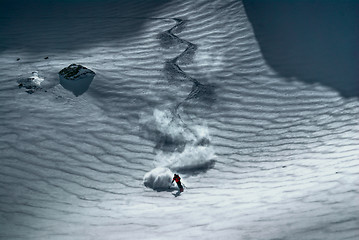 Image showing Male skier riding down the hill