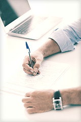 Image showing man signing a contract