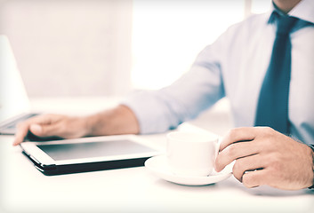 Image showing businessman with tablet pc and coffee in office