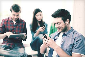 Image showing student looking into smartphone at school