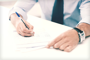 Image showing man signing a contract