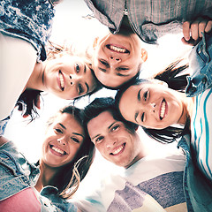 Image showing group of teenagers looking down