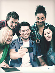 Image showing students looking into smartphone at school