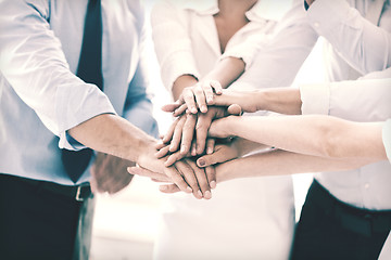 Image showing business team celebrating victory in office