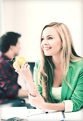 Image showing student girl with green apple in college