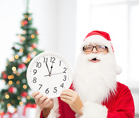 Image showing man in costume of santa claus with clock