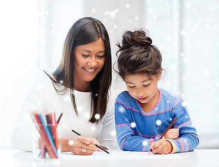 Image showing mother and daughter with coloring pencils indoors