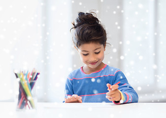 Image showing smiling little girl with pencils drawing at home