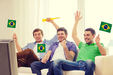 Image showing happy male friends with flags and vuvuzela