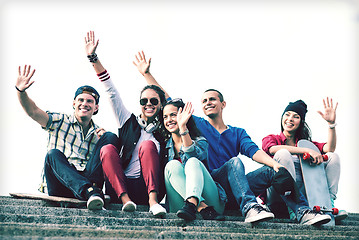 Image showing group of teenagers waving hands