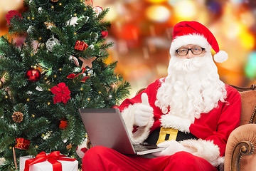 Image showing man in costume of santa claus with laptop