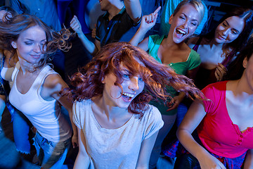 Image showing smiling friends dancing in club