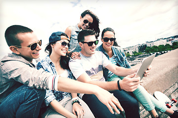 Image showing group of teenagers looking at tablet pc