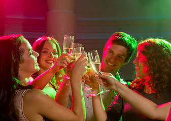 Image showing smiling friends with glasses of champagne in club