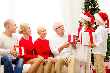 Image showing smiling family with gifts at home