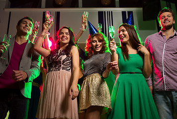 Image showing smiling friends with glasses of champagne in club