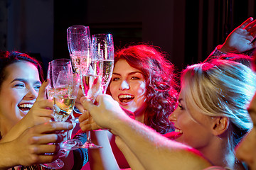 Image showing smiling friends with glasses of champagne in club