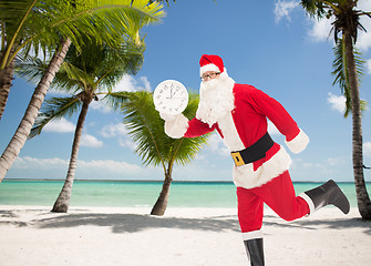 Image showing man in costume of santa claus with clock