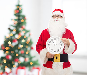 Image showing man in costume of santa claus with clock