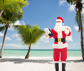 Image showing man in costume of santa claus with notepad and bag