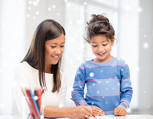 Image showing mother and daughter with coloring pencils indoors