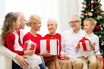 Image showing smiling family with gifts at home