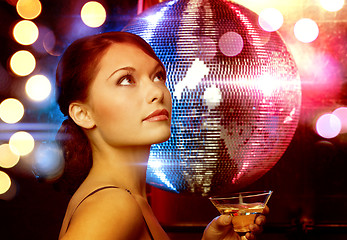 Image showing woman with cocktail and disco ball