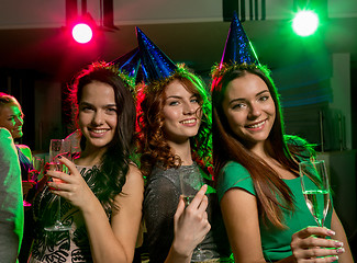 Image showing smiling friends with glasses of champagne in club