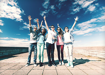 Image showing group of teenagers holding hands up