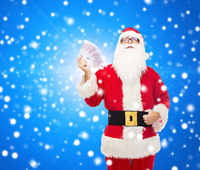 Image showing man in costume of santa claus with euro money