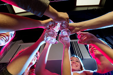 Image showing smiling friends with glasses of champagne in club