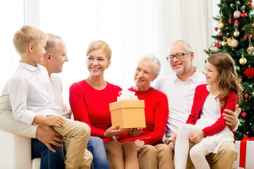 Image showing smiling family with gifts at home