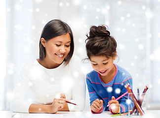 Image showing mother and daughter with coloring pencils indoors