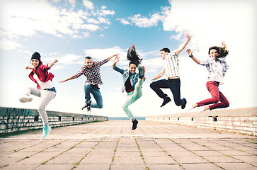 Image showing group of teenagers jumping