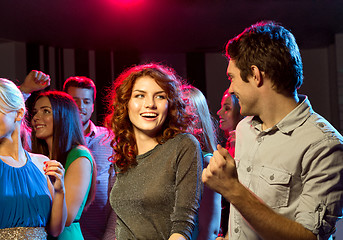 Image showing smiling friends dancing in club