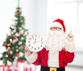 Image showing man in costume of santa claus with clock