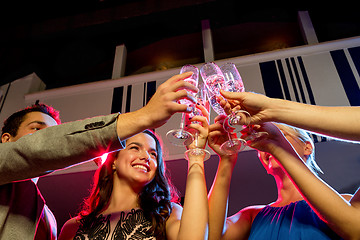 Image showing smiling friends with glasses of champagne in club