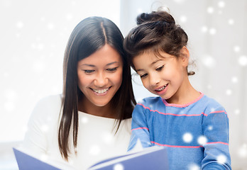 Image showing mother and daughter with book indoors