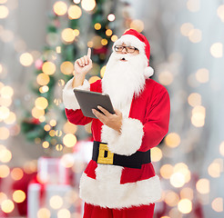 Image showing man in costume of santa claus with tablet pc