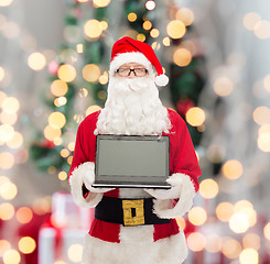 Image showing man in costume of santa claus with laptop