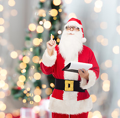 Image showing man in costume of santa claus with notepad