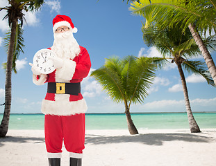 Image showing man in costume of santa claus with clock