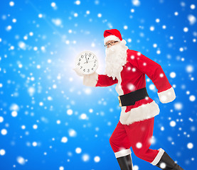 Image showing man in costume of santa claus with clock