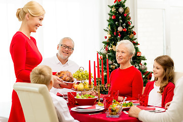 Image showing smiling family having holiday dinner at home