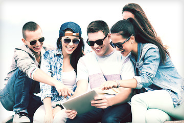 Image showing group of teenagers looking at tablet pc