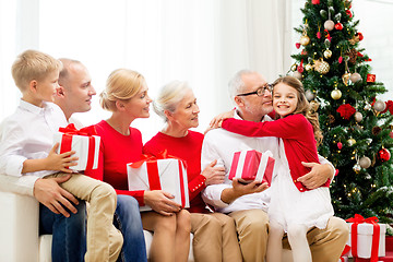 Image showing smiling family with gifts at home